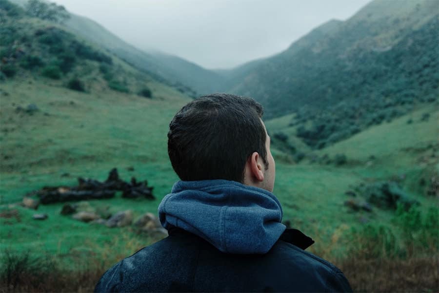 how to change your thoughts, man thinking and gazing at mountains